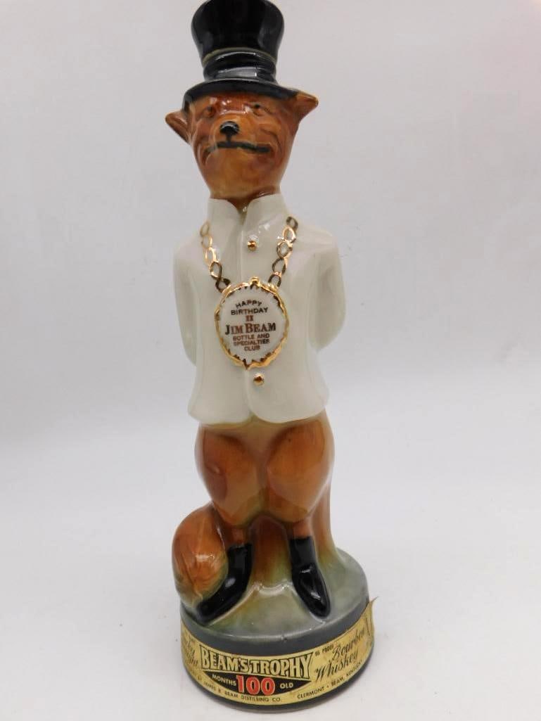 Jim Beam Beam's Trophy Fox Decanter: A James B. Beam ceramic decanter modeled as a fox in white jacket and top hat, as jaunty a character as the mold-maker ever turned out. The medallion reads Happy Birthday II Jim Beam Bottle and Specia