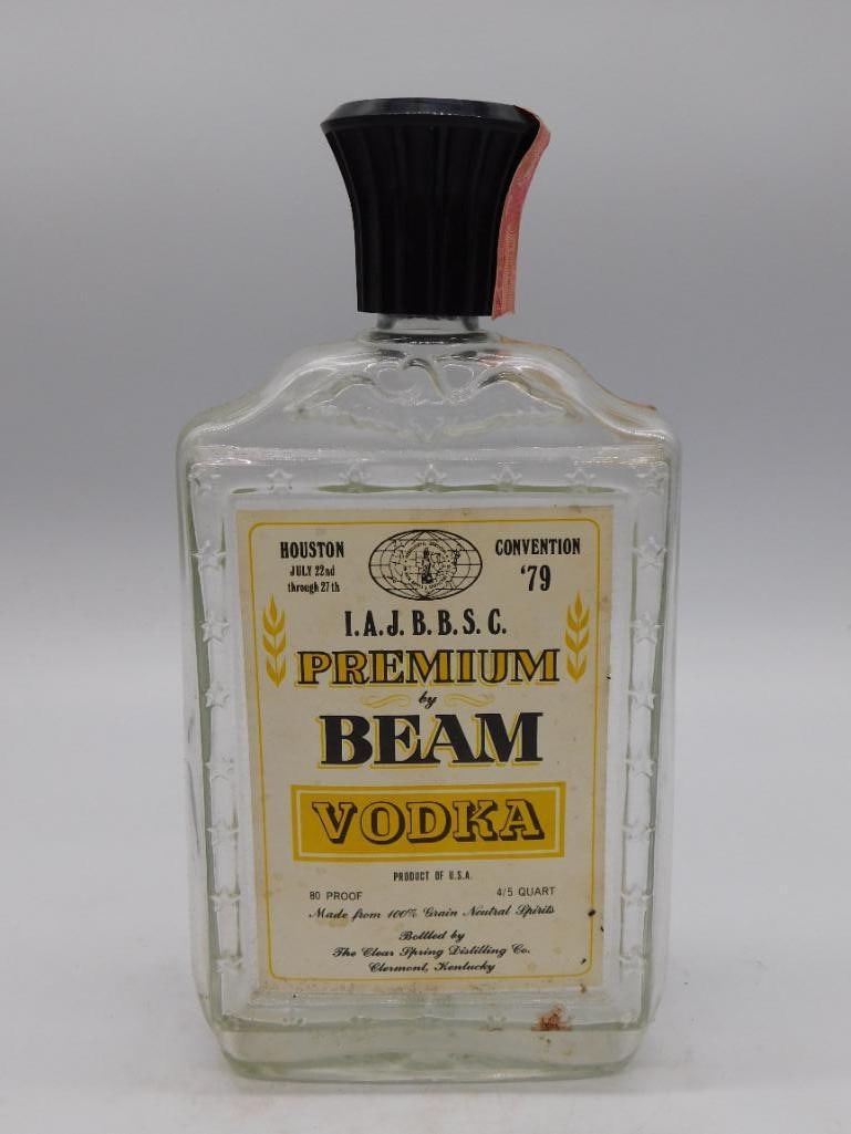 Vintage Beam Vodka IAJBBSC Houston Convention Glass Bottle: Clear pressed-glass square bottle for "Premium by Beam Vodka," produced for the I.A.J.B.B.S.C. Houston Convention, July 1979. Original black plastic cap intact with paper label to the neck. Bottled by
