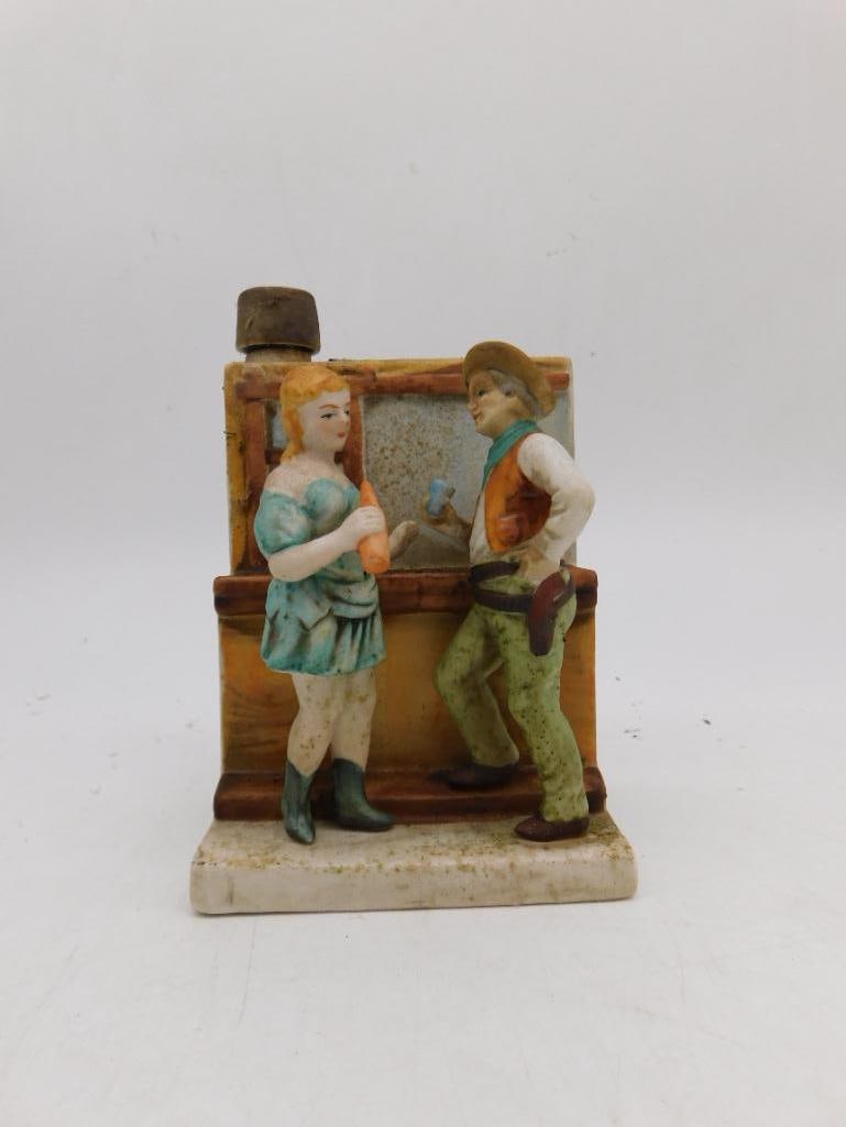 Last Chance Cologne Western Bar Scene Figural Porcelain Bottle: Vintage "Last Chance Cologne" figural porcelain bottle by National Porcelain Company, depicting a saloon girl and cowboy conversing at a bar, six-ounce size, made in Japan per base marking. Cork stopp