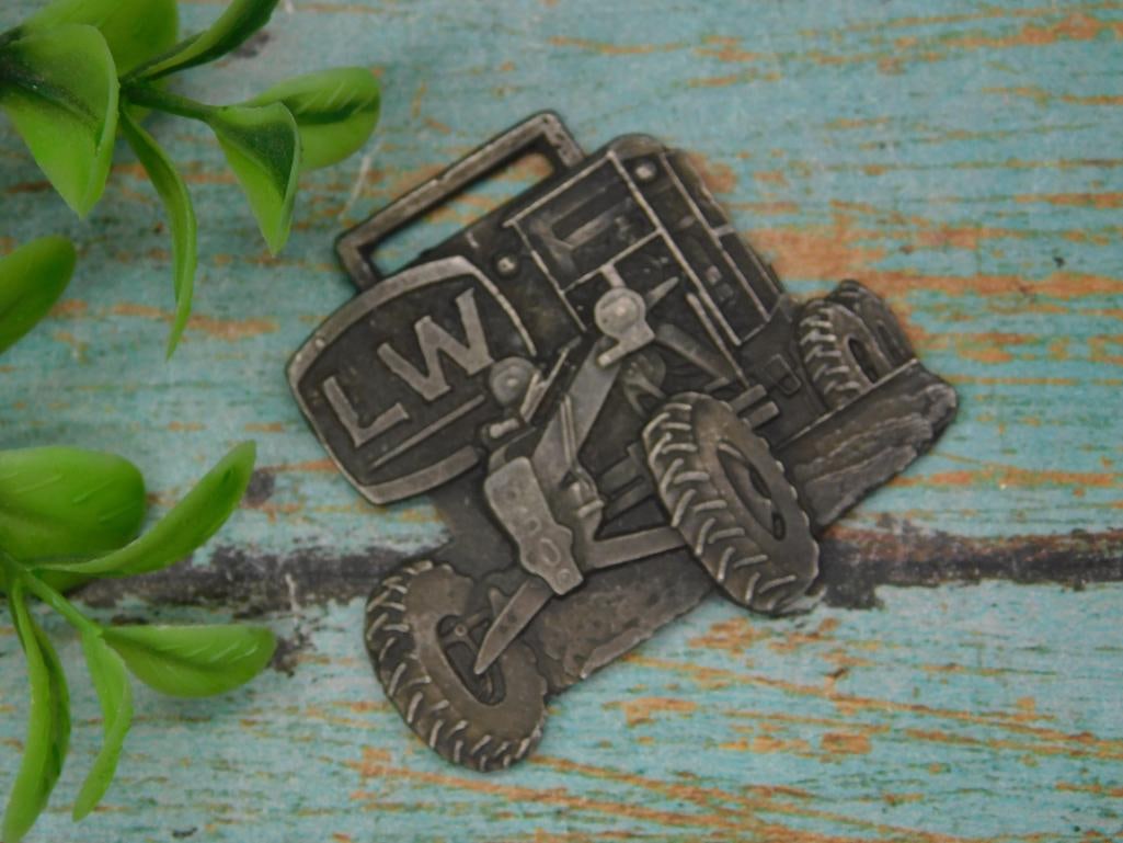 Metal Tractor WATCH FOB with LW Design: Metal Tractor Watch Fob With Lw Design ? Authentic estate find offered in our online auction. Perfect for collectors, resellers, and enthusiasts of vintage, antiques, minerals, rocks, crystals, jewelr