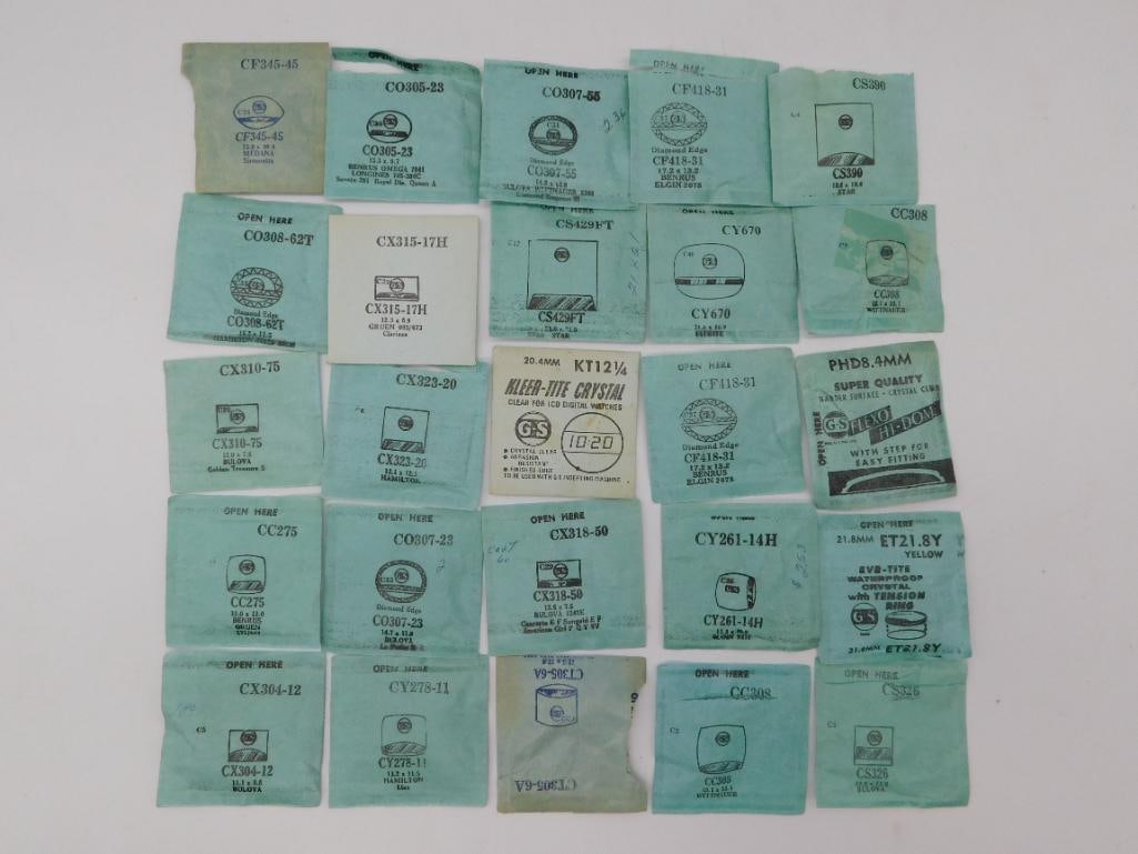 Antique Watch Crystals: Vintage Glass Packets & Loose Lot: 25 new-old-stock watch crystal packets (Wittnauer, Elgin, Bulova, Benrus branding) plus assorted loose clear glass watch crystals in round, square and cushion shapes ranging roughly 0.5 to 1.25 inches