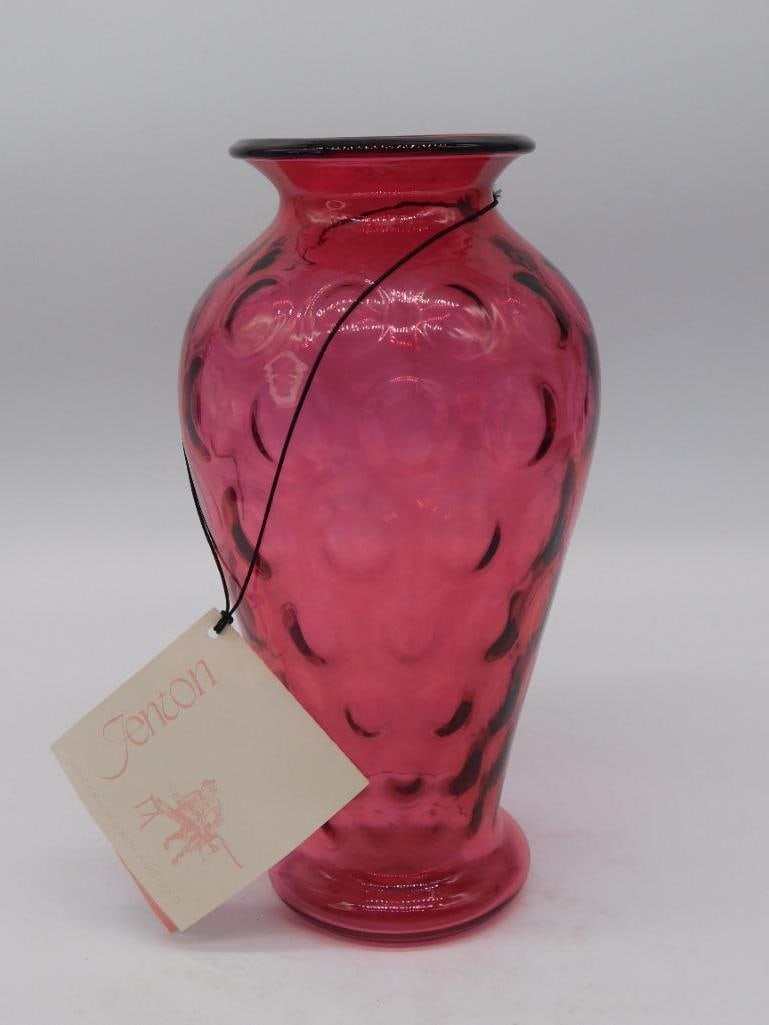 Fenton Cranberry Dot-Optic Art Glass Vase with Original Tag: Ruby-cranberry art glass vase with a dot-optic diamond pattern and a black rolled rim, retaining its original 'Fenton' hang tag. The ruler photographed beside the vase indicates a height of approximat