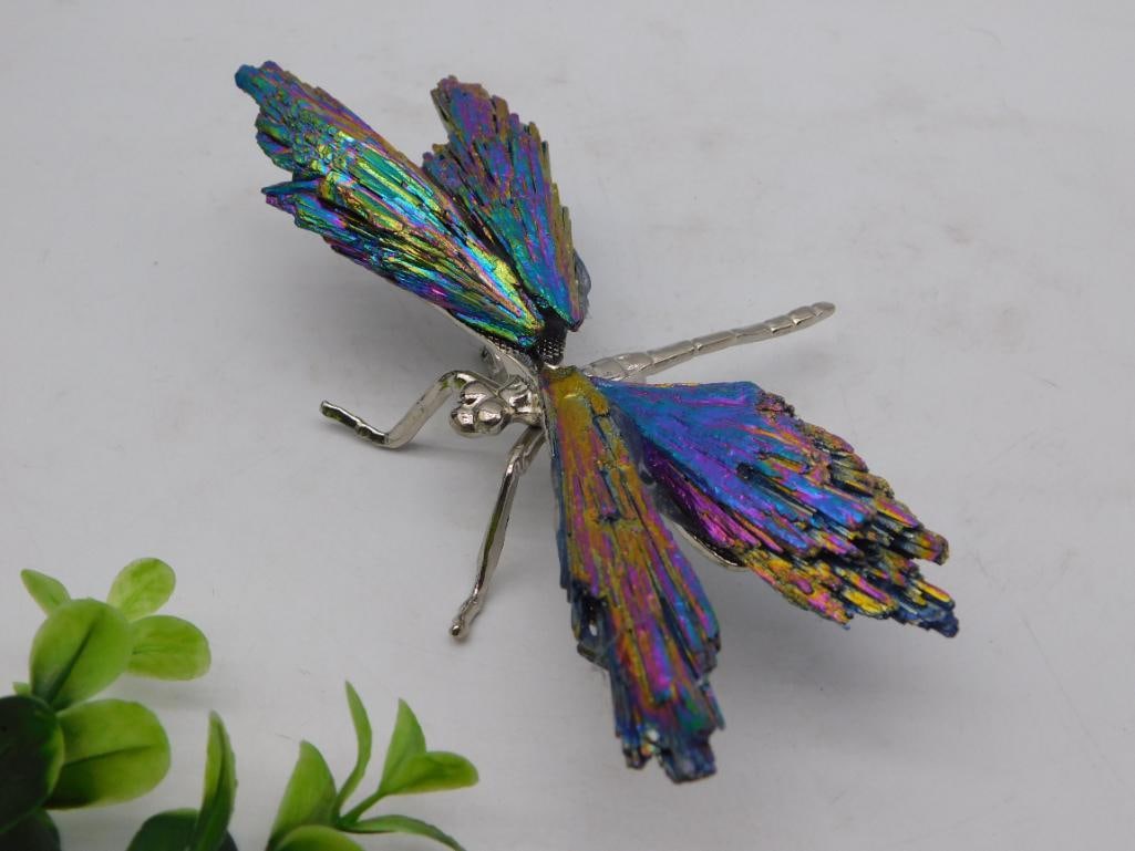 Crystal Figurine - Bismuth Dragonfly, Rainbow Iridescent, 117g: Decorative dragonfly figurine with a silver-tone metal body and legs, featuring wings crafted from iridescent rainbow bismuth crystal. Weighs 117 grams per the included auction tag (lot 715165);