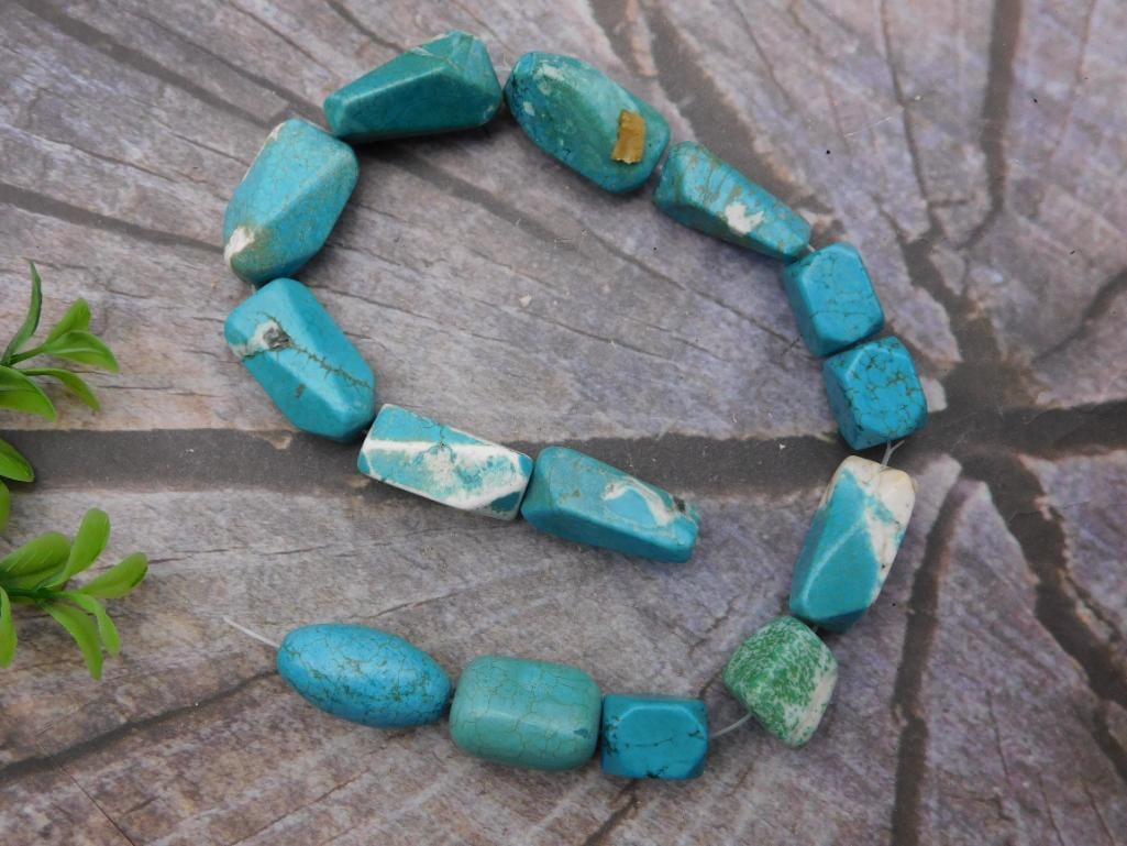 Jewelry Necklace - Turquoise Nugget Bead Strand: Loose strand of chunky, faceted turquoise-colored nugget beads with natural matrix veining, consistent with dyed magnesite or howlite turquoise. Beads range from approximately 15-25mm; the