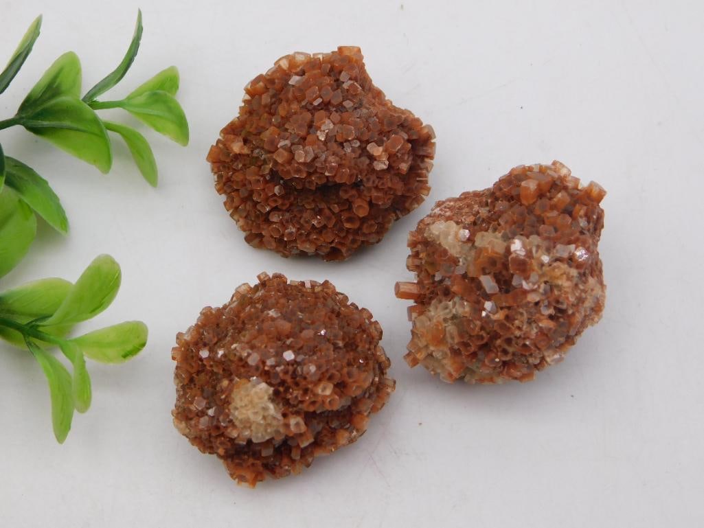 Mineral Specimen - Aragonite Star Clusters, 84 Grams: Set of three natural aragonite crystal clusters displaying the mineral's characteristic sputnik/star-shaped formations in warm amber-brown tones. Combined weight is 84 grams per the included auction