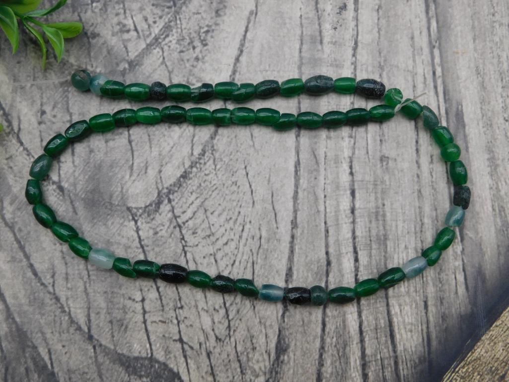 Necklace - Green Jade-Tone Beaded Strand, Banded Stone Beads: Single strand necklace of oval and barrel-shaped stone beads in deep green with dark and milky-white banding, resembling dyed jade or agate. Strung temporarily on wire/thread (unfinished, no clasp);
