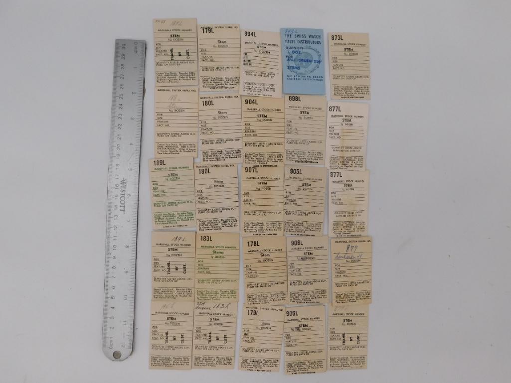 Ephemera: Vintage Marshall Watch Stem Cards and Stems: Approximately 25 "Marshall Stock Number" watch stem reference cards, mostly "Made in Switzerland," with three loose vintage replacement winding stems shown separately, plus a Swiss Watch Parts Distrib