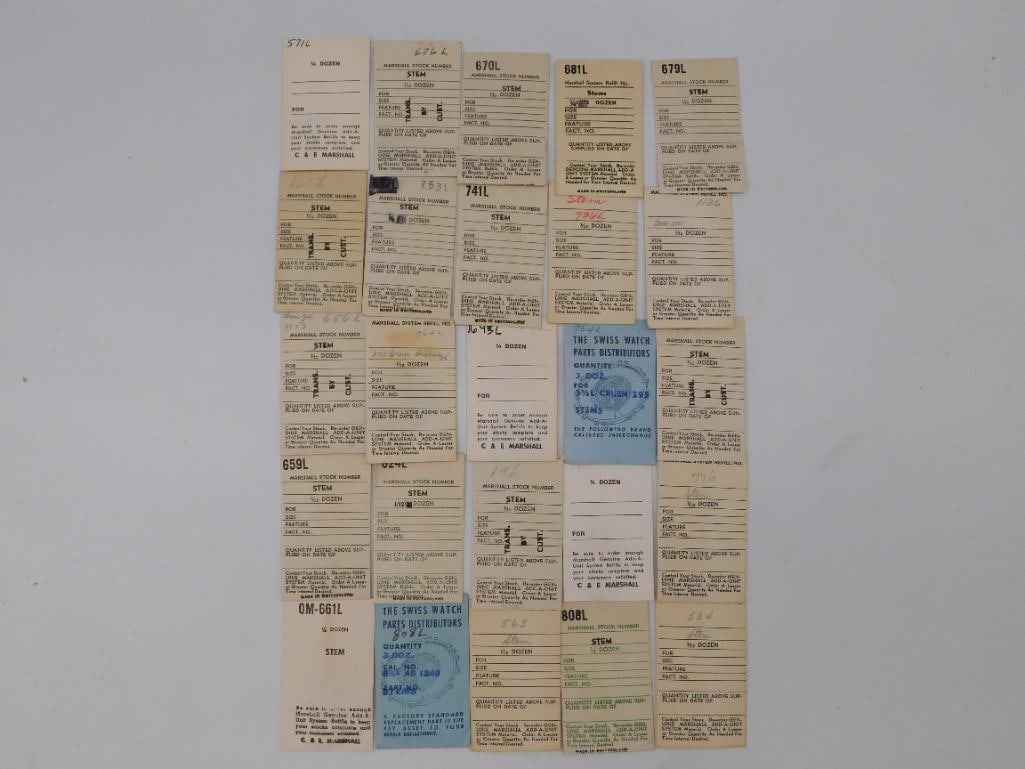 Antique Watch Parts: Marshall System Stem Refill Cards & Stems: Vintage lot of 'Marshall System' and 'Swiss Watch Parts Distributors' stock cards for watch stems (numbers including 670L, 679L, 808L), plus 3 loose brass/steel crown stems measuring approximately 1.5