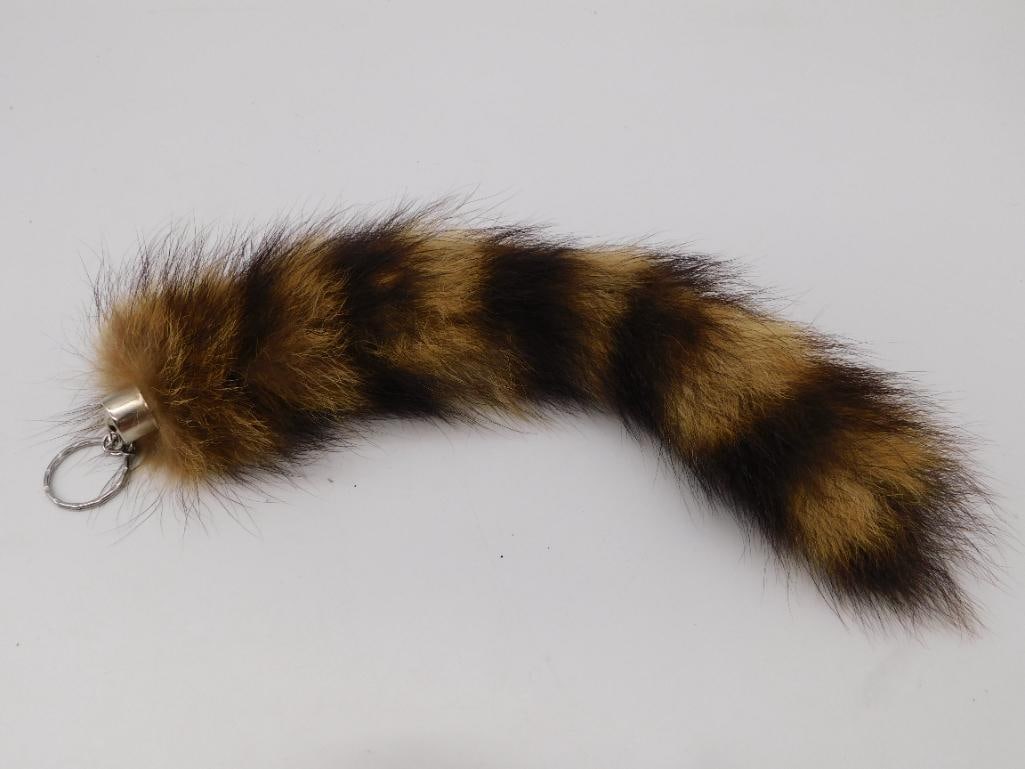 Antique - Vintage Dyed Fur Tail Keychain Fob: Genuine fur tail with a banded tan-and-black pattern, mounted with a silver-tone metal cap and split key ring. Measures approximately 12 inches long as shown against a ruler. Full, soft pile with