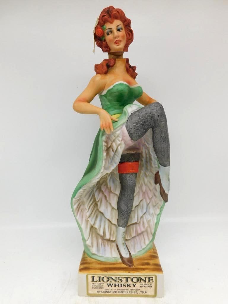 Lionstone The Dance Hall Girl Old West: A Lionstone Old West decanter modeled as a dance hall girl in a green gown, skirts gathered up to show net stockings and a laced boot. The painter did not stint on the red hair or the ruffled