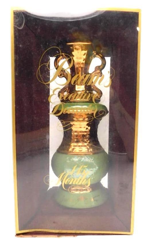 Jim Beam Executive Decanter 115 Months: A stately Jim Beam Executive Decanter, 115 months old, in an ornate urn form with a green porcelain body, gilded scrollwork handles, and gold script lettering. Handsome enough to earn a place on any