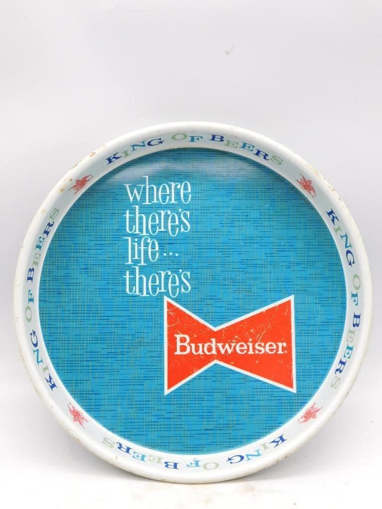 Vintage Budweiser Where There's Life There's Bud Advertising Tray: A round metal Budweiser serving tray in aqua blue bearing the bow-tie logo and the old slogan Where there's life...there's Budweiser King of Beers. Not a decanter but a handsome bit of breweriana for 