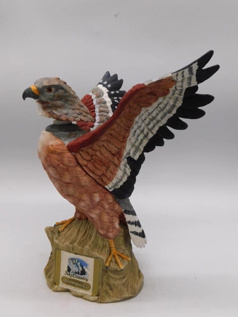 Ski Country Hawk in Flight Ceramic Whiskey Decanter: A Ski Country ceramic decanter modeled as a hawk or falcon on the wing the painted plumage worked out in fine detail above a tree stump base. Approximately 10.5 inches long as photographed in good