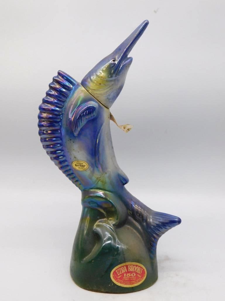 Ezra Brooks Heritage China Sailfish Decanter in Iridescent Luster: A spirited Ezra Brooks decanter modeled as a sailfish breaking water dorsal sail raised and bill thrown skyward. The iridescent blue and green luster shifts with the light and suits the subject admira
