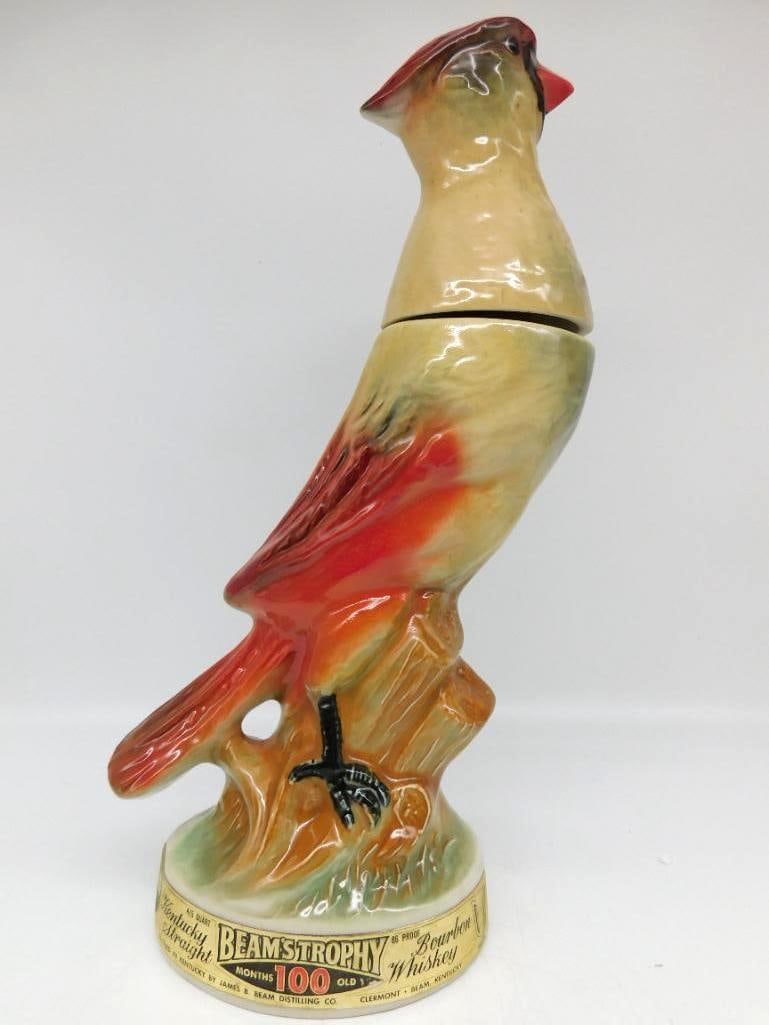 Jim Beam Beam's Trophy Cardinal Bird Regal China Decanter with Hang Tag: A Jim Beam Regal China decanter from the Trophy series modeled as a red cardinal perched upon a dark branch. The plumage is crisply sculpted and the red has kept its warmth. Marked Kentucky Straight B