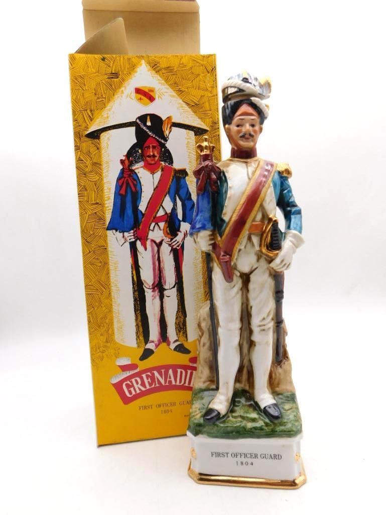 Grenadier First Officer Guard 1804 Porcelain Soldier Decanter with Box: A Grenadier porcelain decanter depicting a uniformed First Officer Guard the base plaque dated 1804. Hand-painted in lively color and the uniform detail rewards a close look. Comes with the original