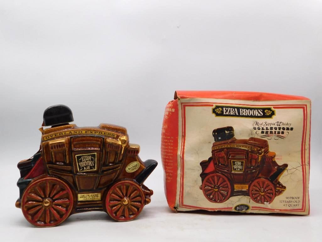 Ezra Brooks Overland Express Stagecoach Decanter with Original Box: A well-turned Ezra Brooks decanter modeled as an Overland Express stagecoach its red spoked wheels and paneled body glazed in warm amber and brown with the driver's seat serving as the stopper. Gilt t