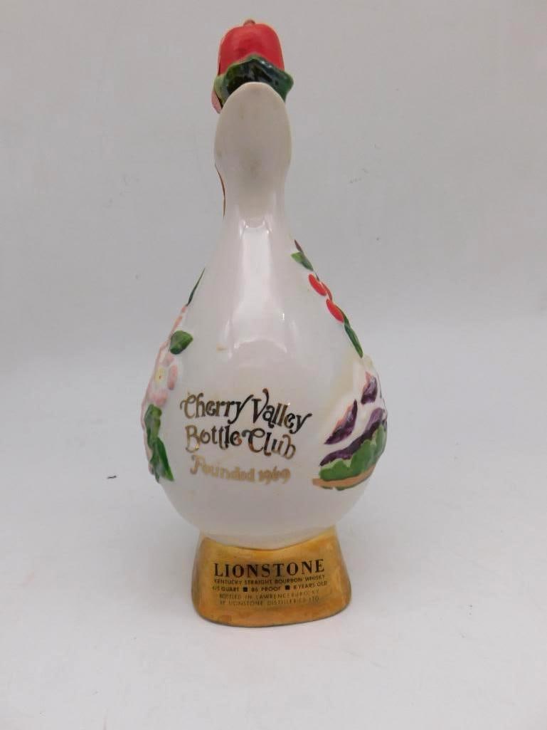 Lionstone Cherry Valley Bottle Club Swan Decanter Hand-Painted Florals: A Lionstone porcelain decanter in the form of a swan for the Cherry Valley Bottle Club lettered Founded 1969. Hand-painted with cherries and floral sprays with gold-tone base and beak. The Kentucky St