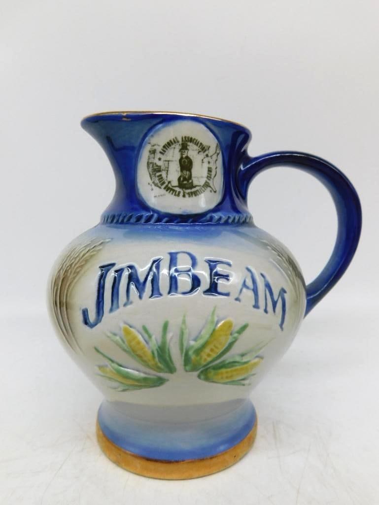 Jim Beam Bottle Club Cobalt Pitcher Decanter with Corn and Wheat Relief: A small Jim Beam pitcher decanter glazed cobalt at the neck and handle the pale body molded in relief with ears of corn and a sheaf of wheat and lettered JIM BEAM across the front. A printed medallion