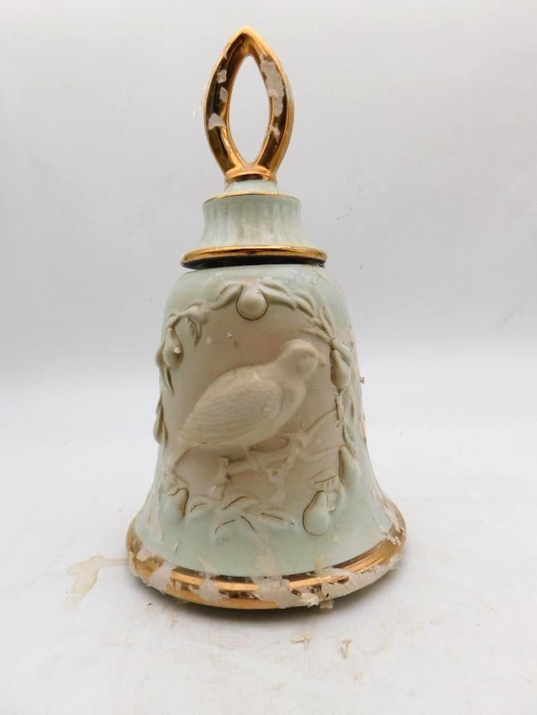 Jim Beam Regal China Bell Decanter with Molded Bird and Pears: A Jim Beam bell-form decanter in pale celadon the body worked in white relief with a bird perched among pear-laden branches and a gilt ring handle above. Approximately 8 inches tall with gilt bands at