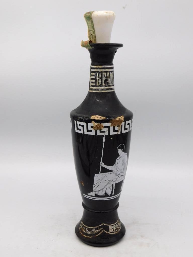 Jim Beam Black Grecian Urn Decanter with Greek Key and Classical Figures: A Jim Beam decanter turned in the shape of a Grecian urn glazed a deep black and printed in white with a seated classical figure and a band of Greek key. A sober well-turned form and the white