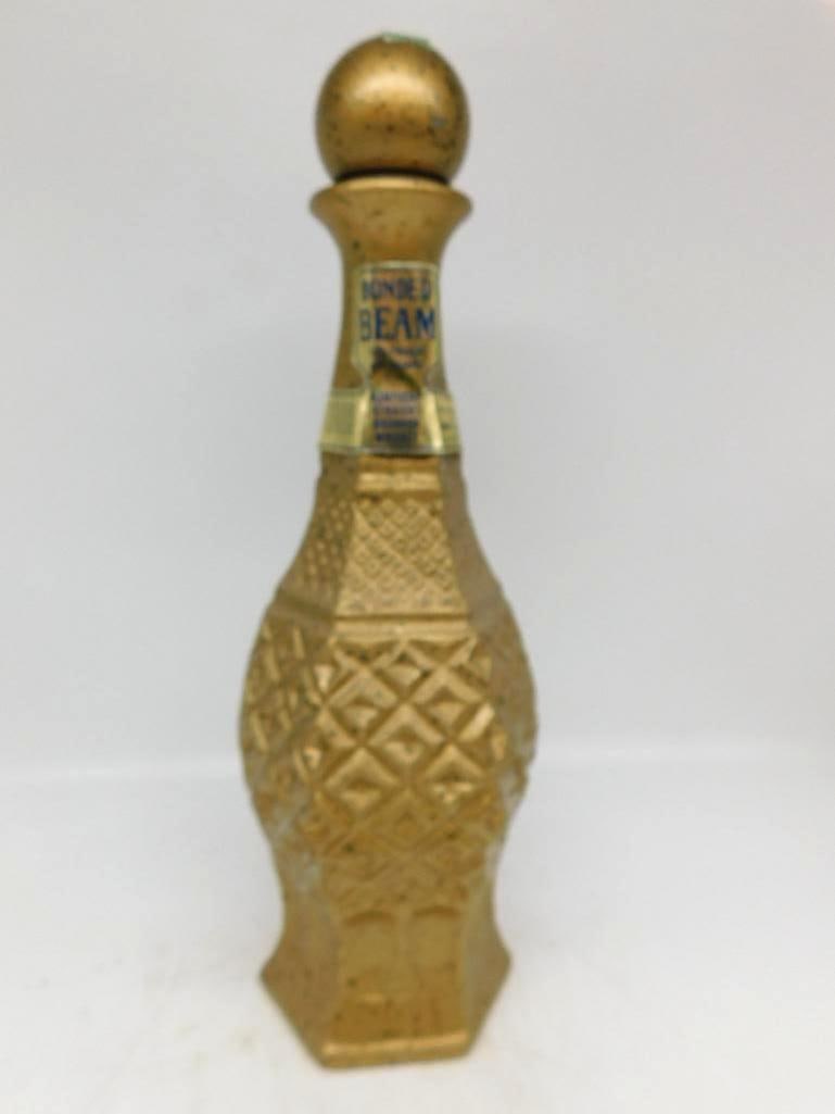 Bonded Beam Gold-Painted Diamond Pattern Glass Whiskey Decanter: A trim Bonded Beam glass decanter finished overall in gold paint the body pressed in a diamond and lattice pattern above a paneled foot and topped with a ball stopper. The neck carries its printed Bon