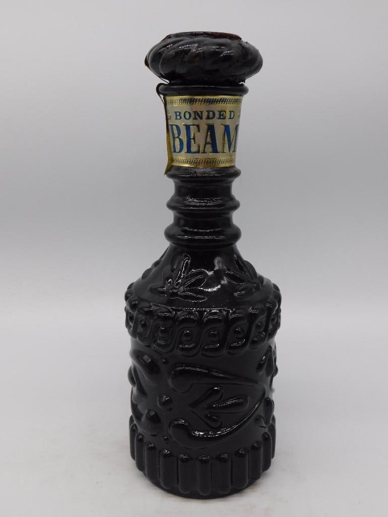 Black Glass Basketweave-Pattern Whiskey Decanter Gold Foil Neck Label: A black glass decanter with a molded woven basketweave texture and a gold-tone cap wearing a gold foil paper neck label. The label text is only partially legible in the photos and could not be confirm