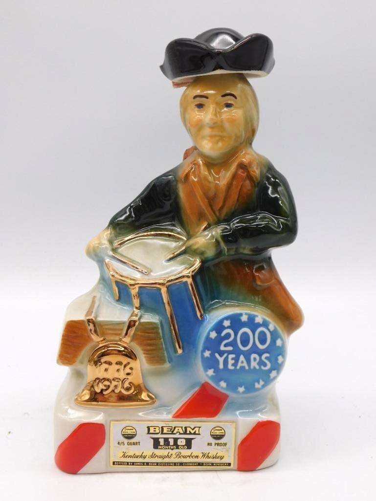 Jim Beam Bicentennial Drummer Boy and Washington Evergreen State Decanters Pair Seal Intact: Two Jim Beam Regal China decanters offered together. The first is a Bicentennial drummer boy marking 1776-1976 with a gilded Liberty Bell accent; the second a Washington The Evergreen State statehood