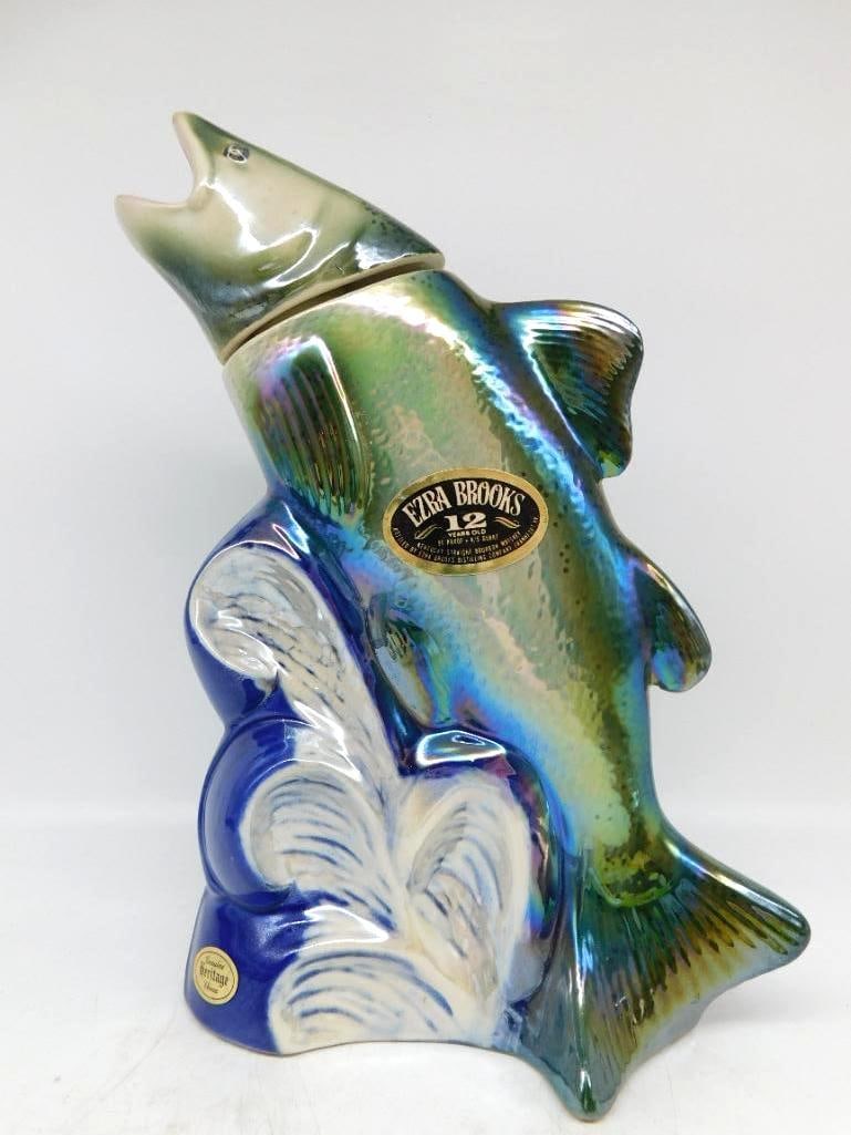 Ezra Brooks Washington State King Salmon Decanter Seal Intact: A spirited Ezra Brooks decanter modeled as a king salmon leaping clear of the whitecaps the whole finished in an iridescent luster glaze that shifts from green to blue as it turns. The molded scales