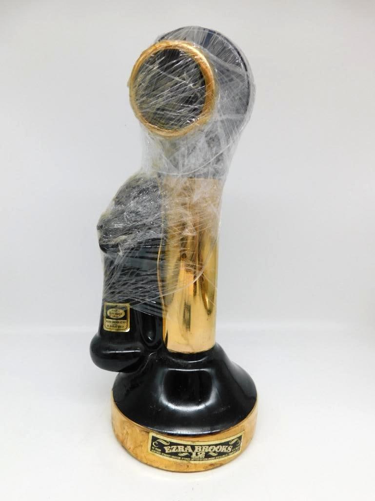 Ezra Brooks Candlestick Telephone Decanter Heritage China Seal Intact: An Ezra Brooks Heritage China decanter cast as a black and gold candlestick telephone still wrapped in its original protective plastic film as issued. A second example offered in this sale.