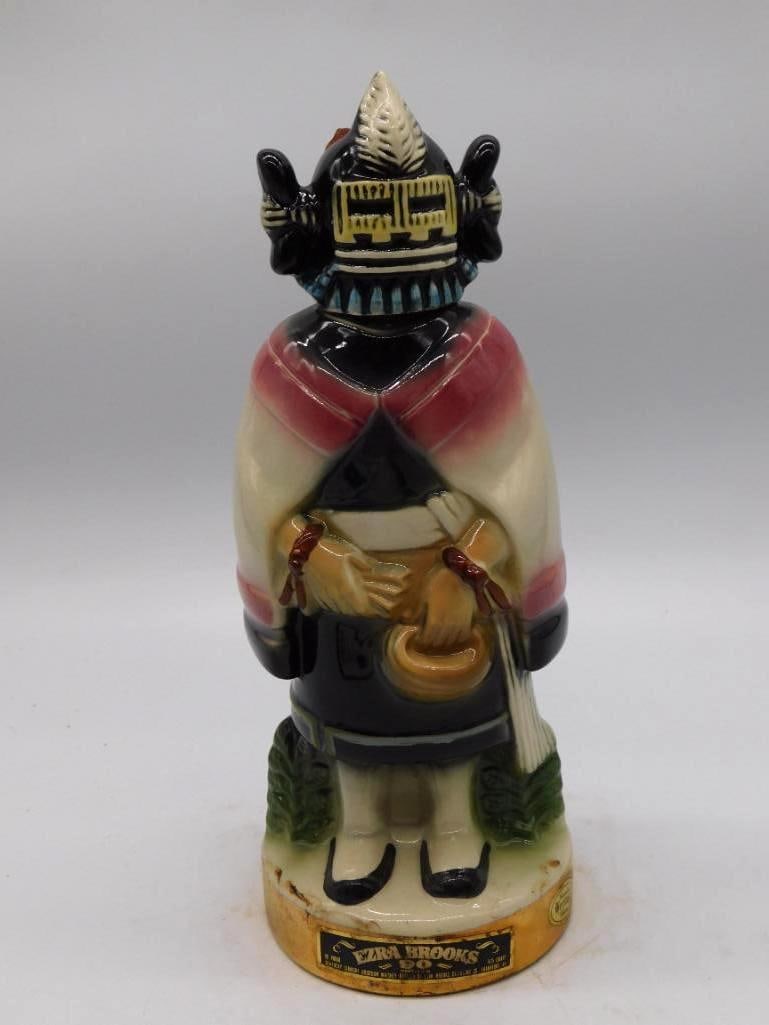 Ezra Brooks Shriner Bust Ceramic Whiskey Decanter Seal Intact: An Ezra Brooks ceramic decanter modeled as a fraternal Shriner bust in a black and gold fez with pink and black robe. The original tax stamp remains intact across the neck which is to say the bottle