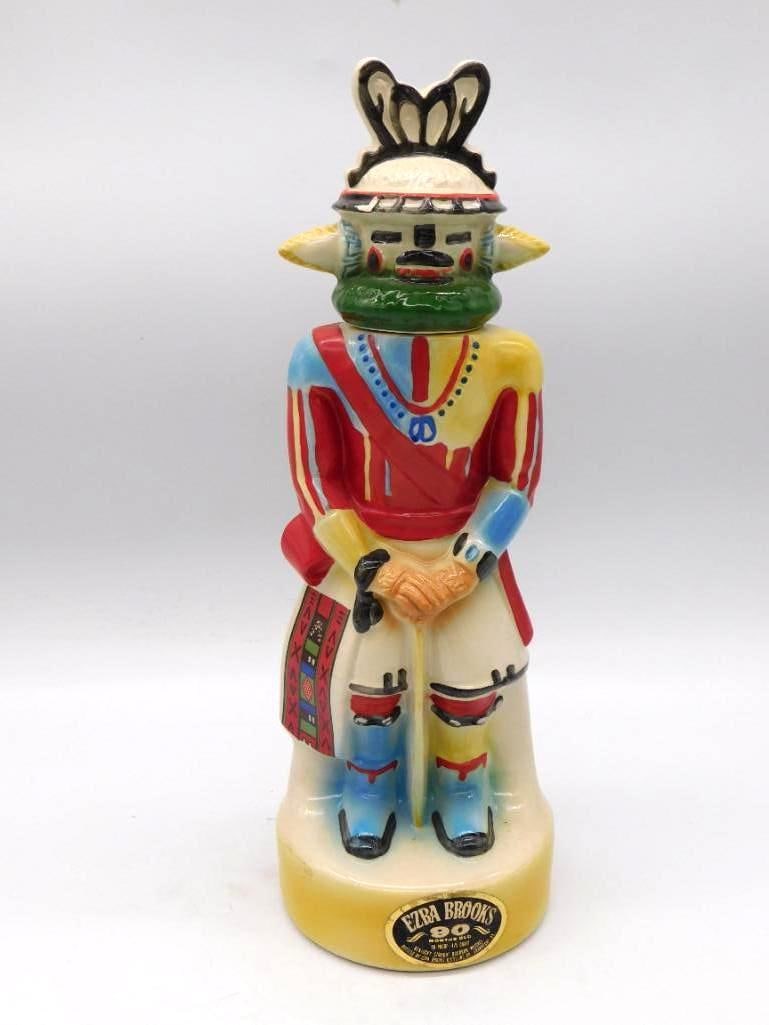 Ezra Brooks Kachina Southwestern Ceramic Decanter Red and Blue: An Ezra Brooks ceramic decanter rendered as a Southwestern Kachina figure the green mask set above ceremonial dress of red blue and yellow. The colors have held their brightness and the molded detail 
