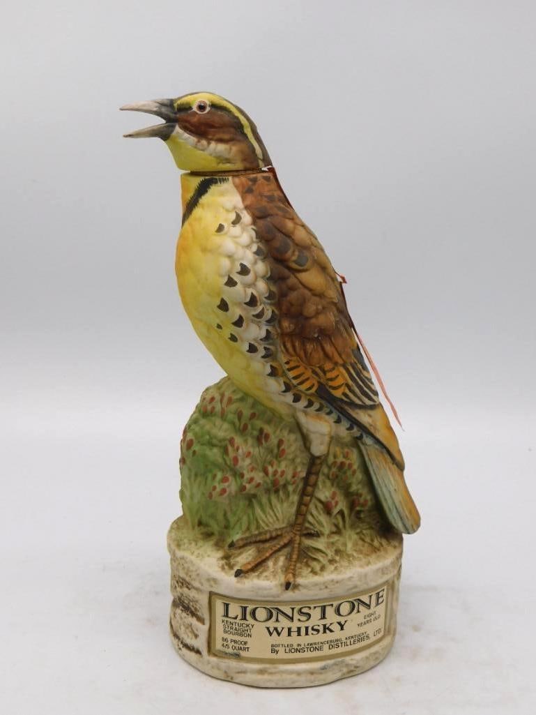 Lionstone The Meadowlark Bird Decanter Wyoming State Bird in Song: A Lionstone decanter modeled as a meadowlark perched on a grassy hummock bill open in full song. The painting is admirable a black necktie across the bright yellow breast mottled brown wings and a liv
