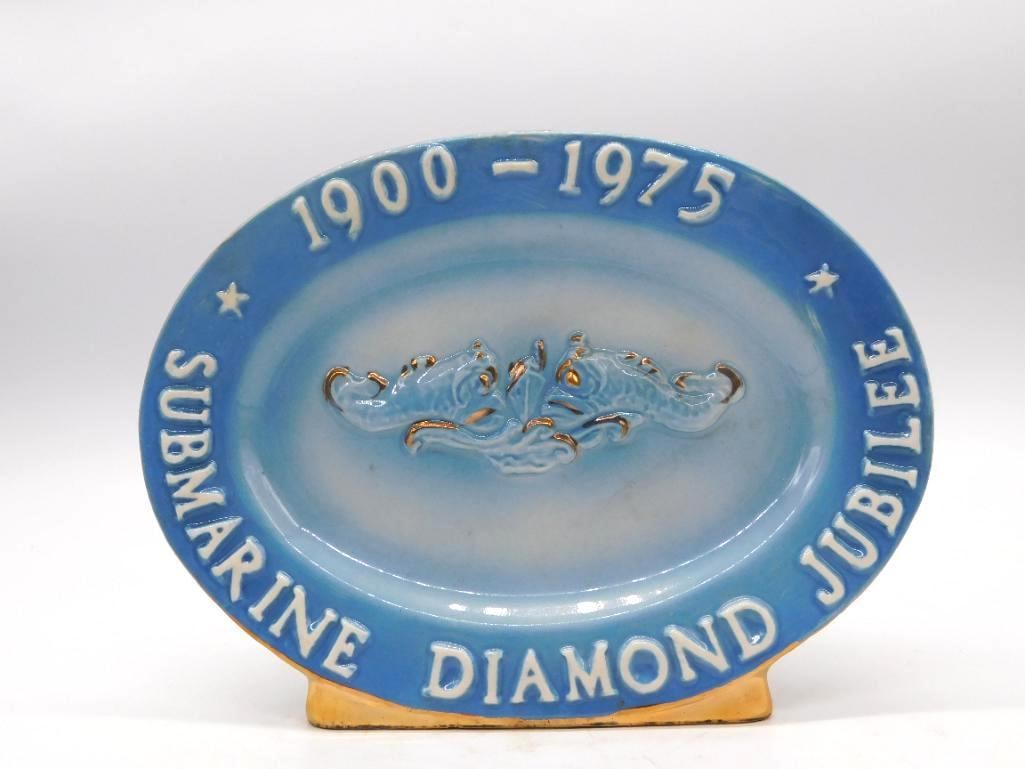 U.S. Submarine Veterans WWII Diamond Jubilee Commemorative Decanter: A ceramic commemorative decanter for the U.S. Submarine Veterans of World War II marking the Submarine Diamond Jubilee 1900-1975. Oval in form with a molded submarine emblem a sober and workmanlike