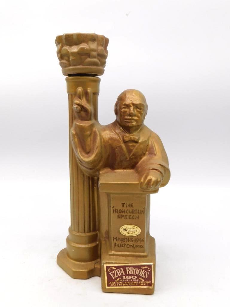 Ezra Brooks Heritage China Churchill Iron Curtain Speech Decanter Fulton Missouri: An Ezra Brooks Heritage China decanter finished throughout in gold modeled as Winston Churchill at a lectern with two fingers raised in the victory sign a fluted column at his side serving as the neck
