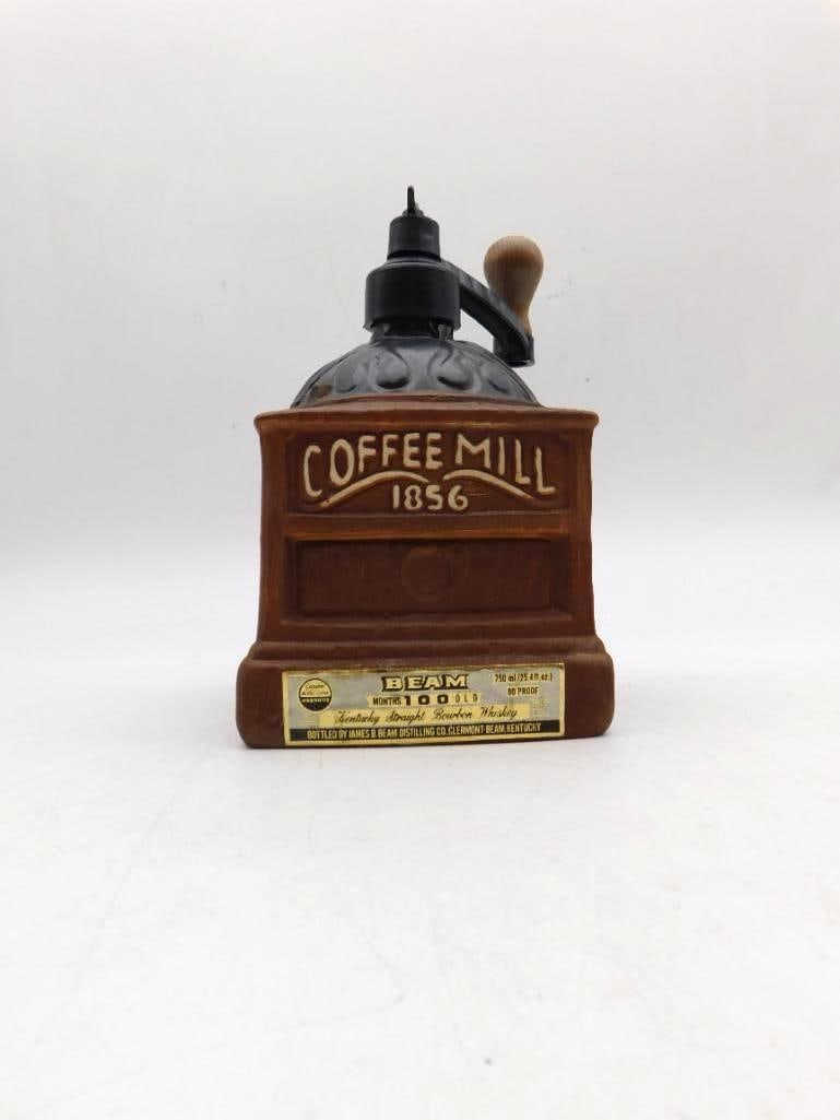 Jim Beam Coffee Mill 1856 Regal China Bourbon Decanter: A Jim Beam Regal China decanter modeled as an antique coffee grinder and marked Coffee Mill 1856 retaining the original gold Beam neck label reading 100 Months Old. An agreeable kitchen novelty in goo