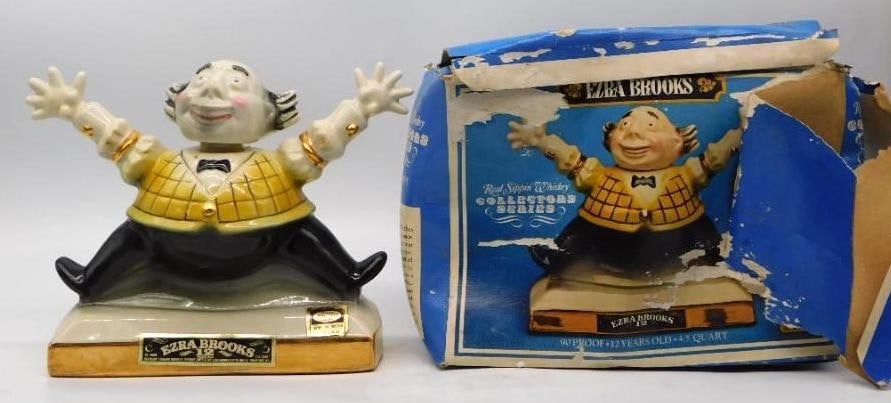 Ezra Brooks Collectors Series Seated Jolly Gentleman Decanter with Original Box: An uncommonly genial Ezra Brooks Collectors Series decanter modeled as a stout fellow seated with both arms flung wide in welcome dressed in a yellow lattice-check jacket black bow tie and gilt cuffs.