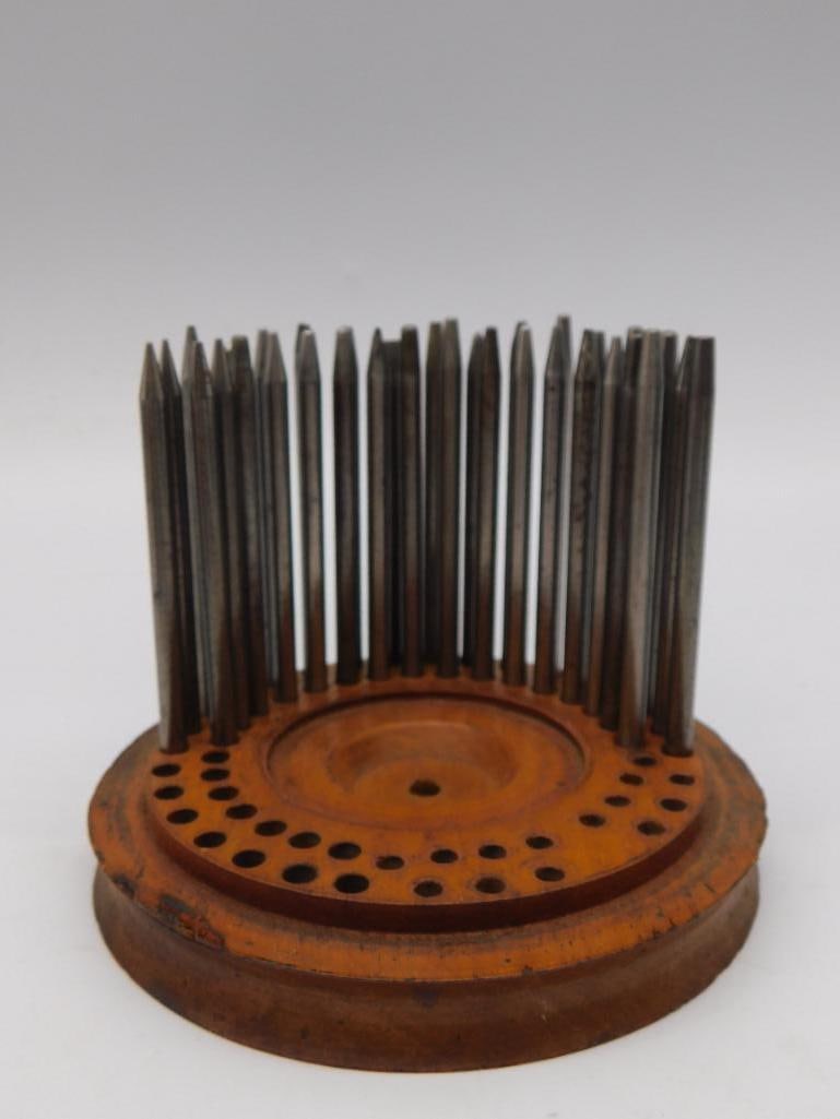 Tool: Antique Wood WATCHMAKER PUNCH Holder with Steel Punch Set: Wooden K & D AND OTHER PUNCHES pincushion-style holder fitted with approximately two dozen steel awls and punches, one shank stamped "S66 K&U." A ruler photo shows the piece stands roughly 5 inches ta