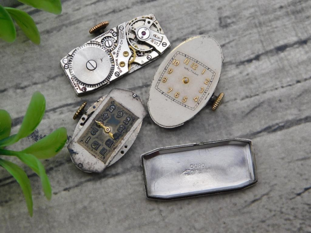 Lot of 4 Vintage Watch Movements - Bulova, Waltham, Duro: Group of four vintage wristwatch movements and parts including a Bulova Watch Co. movement, a Waltham-signed oval dial and movement with crown, an unmarked small rectangular dial and movement, and a s