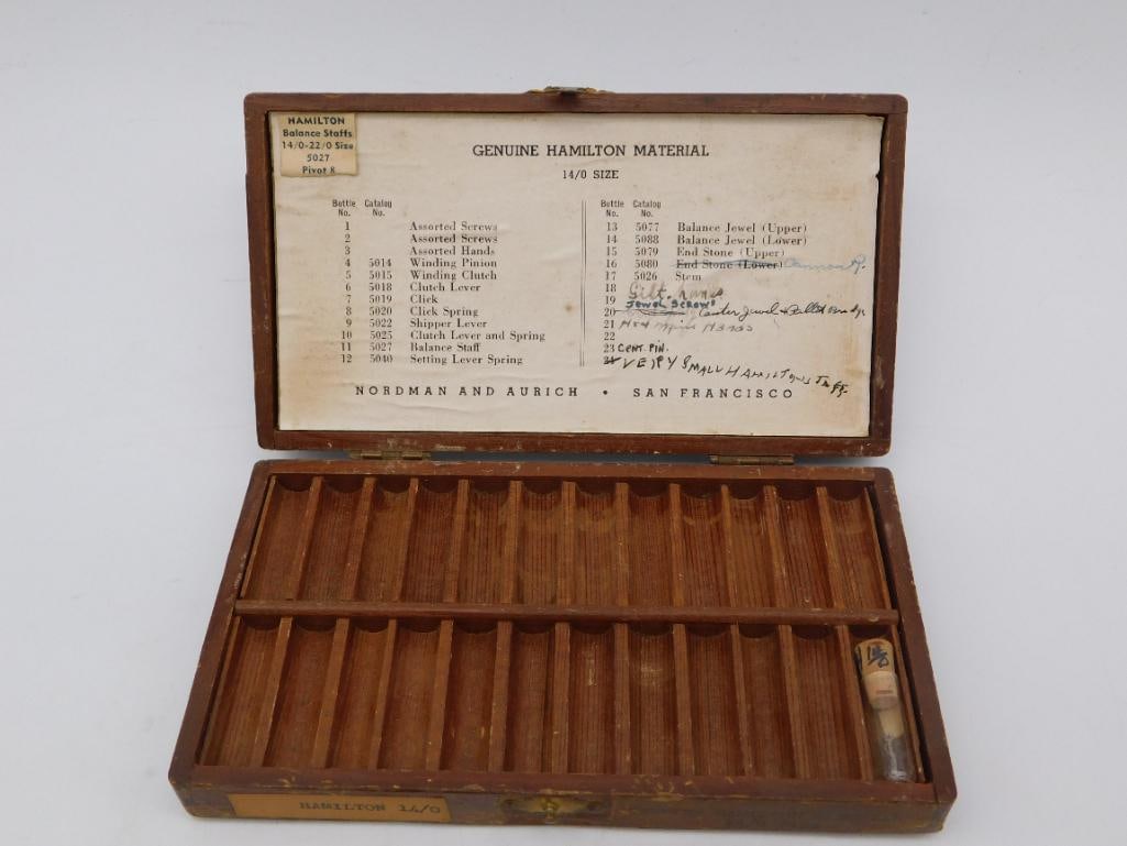 Genuine Hamilton Watch Material Box - Nordman & Aurich: Vintage wooden watchmaker's parts box titled "Genuine Hamilton Material, 14/0 Size," distributed by Nordman and Aurich of San Francisco, with a printed reference card listing assorted screws, hands, w