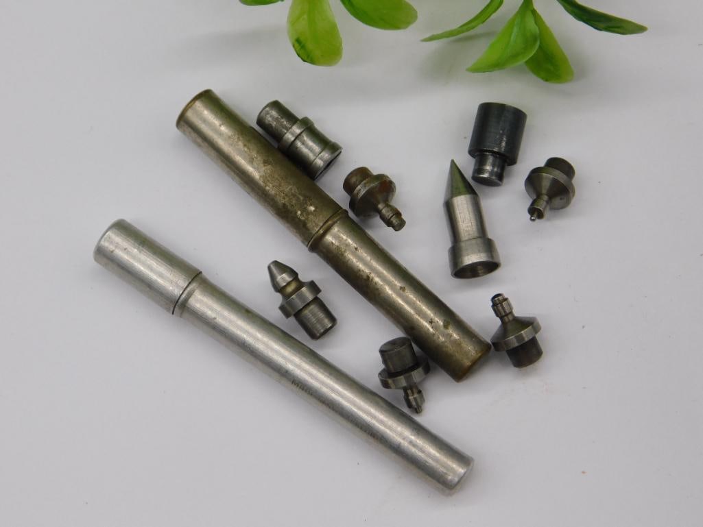 Watchmaker Staking Punches with Two Knurled Handles: Two knurled-handle watchmaker punch tools (one aged brass-tone, one polished steel) together with seven assorted staking set dies, including a sharply pointed cone-tip punch. Used for watch case,