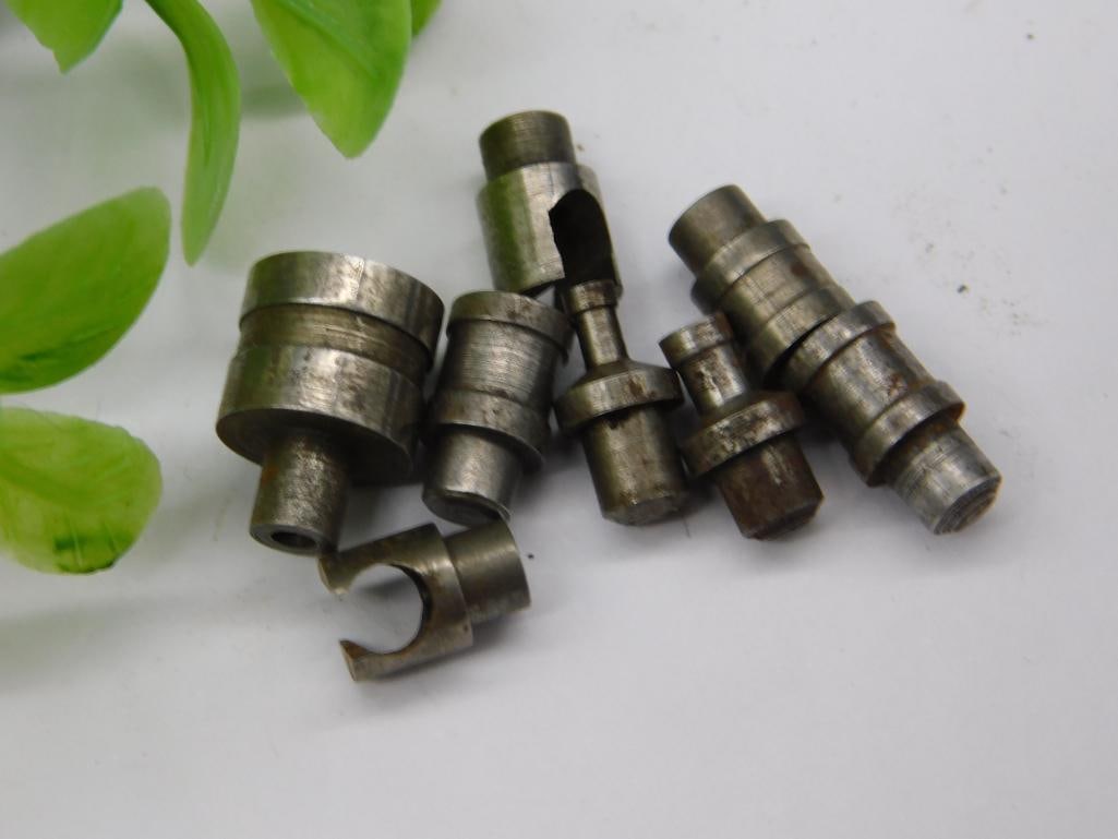 Lot of Watchmaker Staking Punches with Notched Collets (7 pcs): Seven watchmaker staking set punches and dies, including a notched, horseshoe-shaped open collet and a forked-tip punch, in an aged steel finish. Used for watch case and movement work on a staking