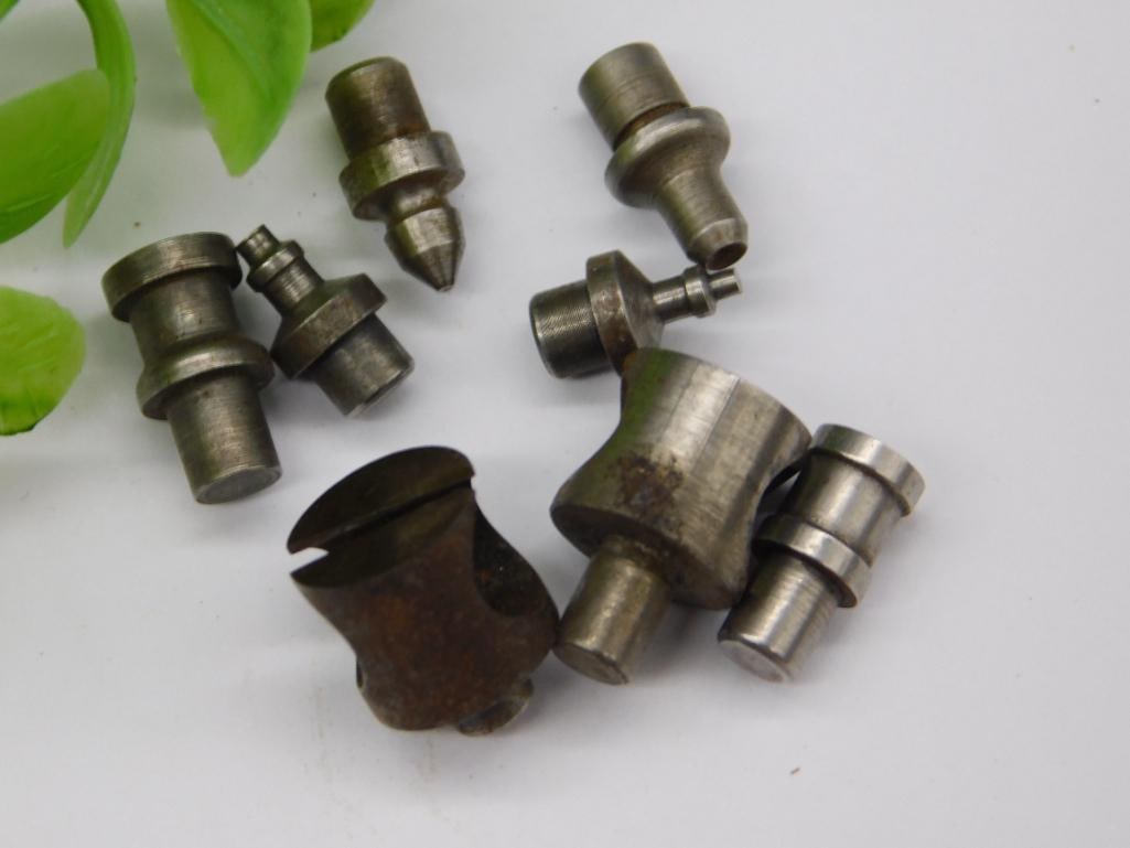 Watchmaker Staking Dies with Large Cup Punch (8 pcs): Eight watchmaker staking set punches and dies, including one larger hollow, rust-toned cup-shaped die and a pointed punch, in mixed steel finishes. Used for watch case and jewel work. See photos for