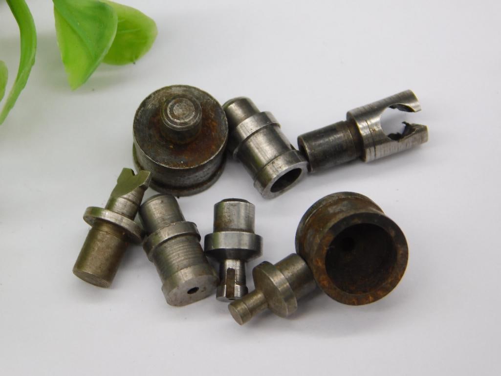Watchmaker Staking Dies with Rusted Cup Punch (8 pcs): Eight watchmaker staking set punches and dies, including a wide hollow cup-shaped die with heavy surface rust and a forked-tip punch, remainder in a lighter steel finish. Used for watch case and