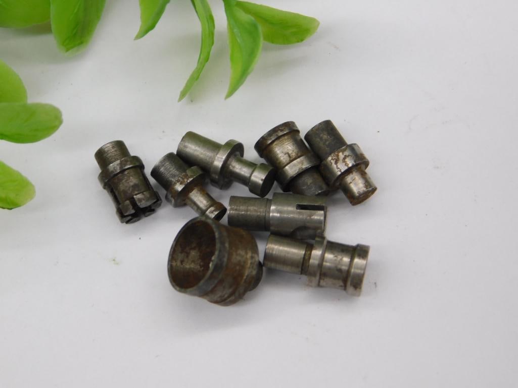 Watchmaker Staking Dies with Large Rusted Cup (8 pcs): Eight watchmaker staking set punches and dies, including a wide, heavily rusted hollow cup-shaped die and a notched forked-tip punch, remaining pieces in a mixed steel finish. Used for watch case and