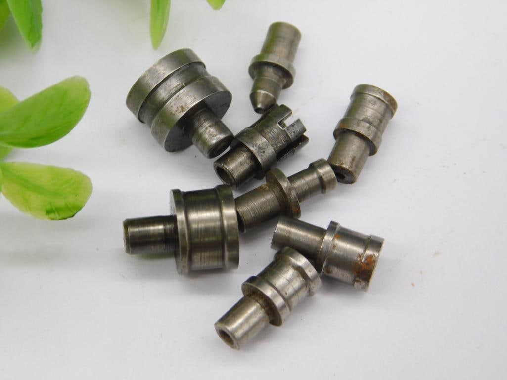 Lot of Watchmaker Staking Set Punches (8 pcs): Eight assorted watchmaker staking set punches and dies, including one notched forked-tip punch, in a worn steel finish with light rust. Used for watch case and jewel work on a staking tool. See