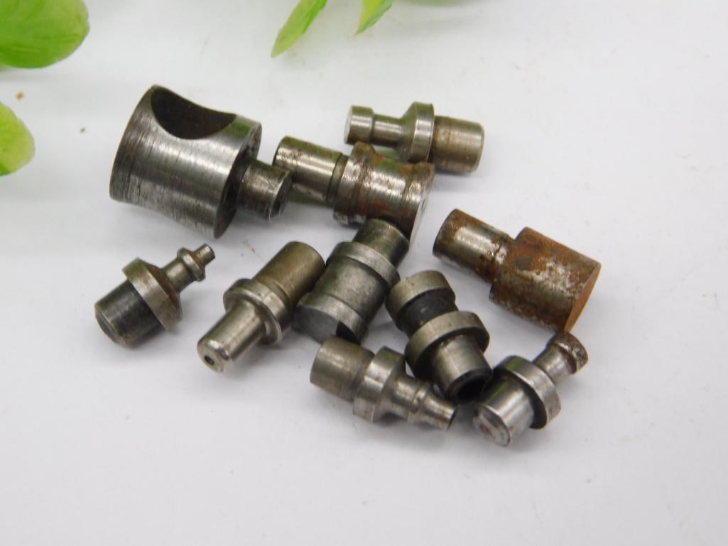 Watchmaker Staking Dies with Rusted Cup & Forked Punch (9 pcs): Nine watchmaker staking set punches and dies, including a large hollow, rust-toned cup-shaped die and a notched forked-tip punch, remainder in a mixed steel finish. Used for watch case and movement