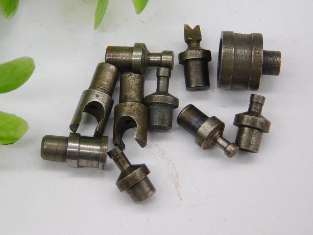 Watchmaker Staking Punches with Notched Collets (9 pcs): Nine watchmaker staking set punches and dies, including two open notched collet dies and a forked-tip punch, in mixed steel finishes with some surface rust. Used for watch case and movement work. See