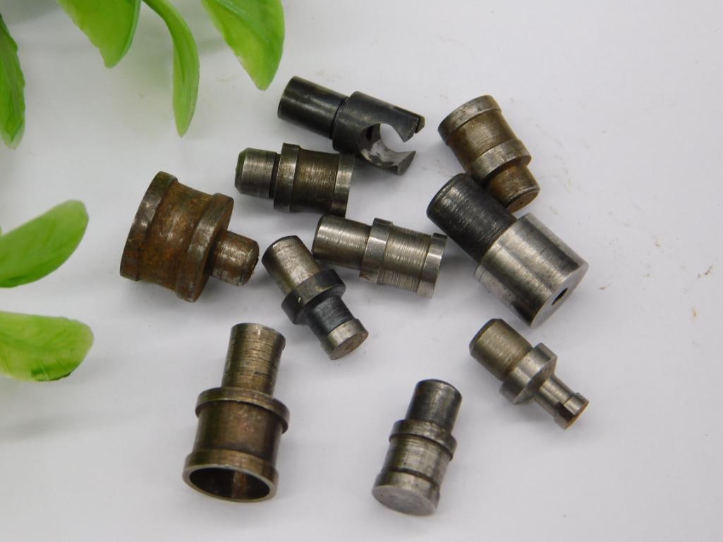 Watchmaker Staking Set incl. Brass-Tipped Rod Tool: A mixed lot of unmarked watchmaker staking-set stakes including a rod tool with a brass end cap, a bright polished cup-shaped piece, a squared block-form stake, and several standard cupped stakes.