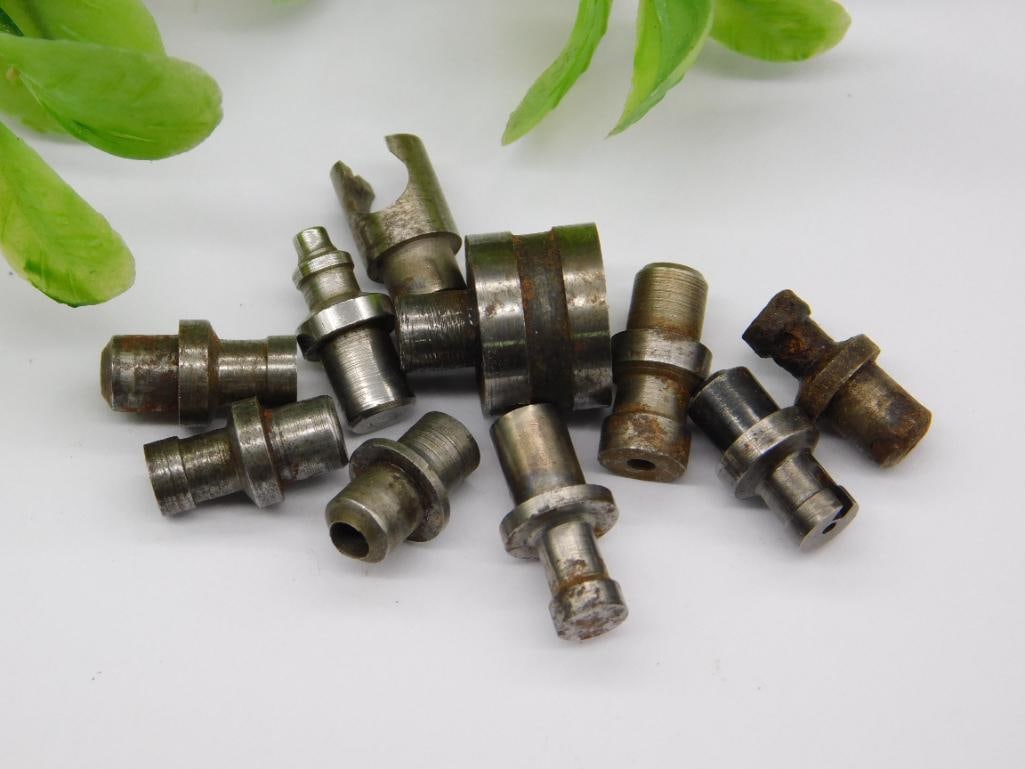 Watchmaker Staking Tool Punch Assortment: Group of roughly ten small steel machined parts with cupped, pointed, and flared tips on stepped shafts, typical of a watchmaker's staking tool punch set. Light rust present on a few pieces.